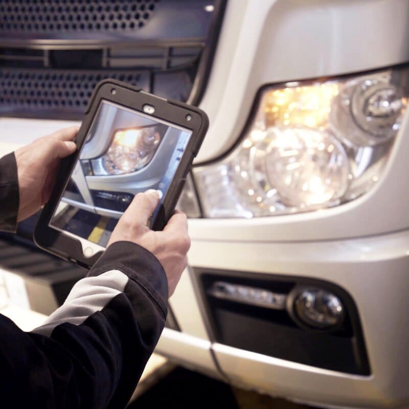 Tablet taking a photo of a fleet vehicle using the fleet management system.